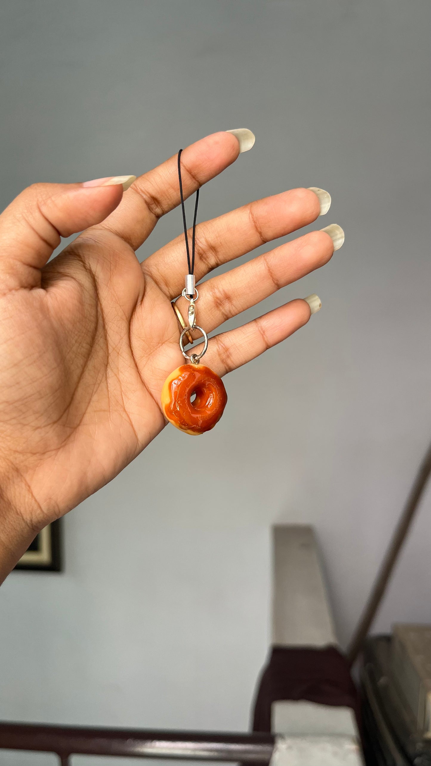 Donut with chocolate syrup charm